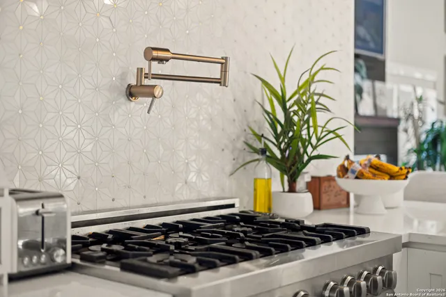 a kitchen with a sink a counter top space and a fireplace