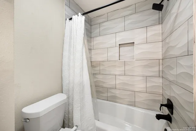 a en suite bathroom with a sink a toilet and a mirror