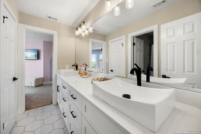 a bed room with a bed and a chandelier