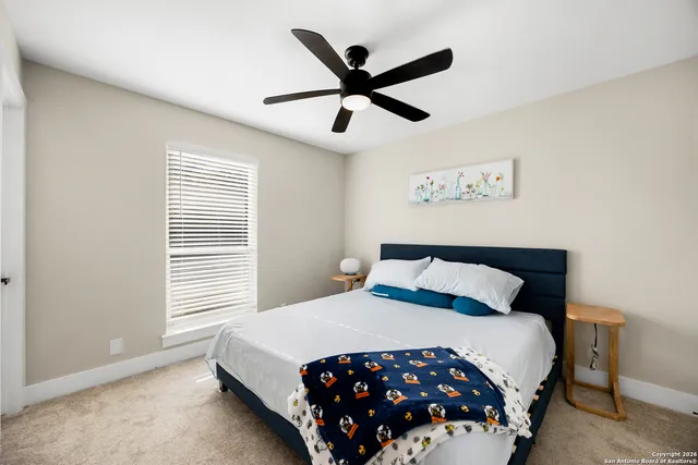 a room with kitchen island granite countertop a sink cabinets and wooden floor