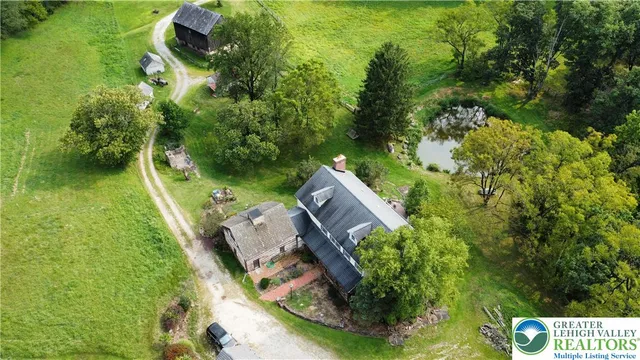 an aerial view of a house with a yard basket ball court and outdoor seating