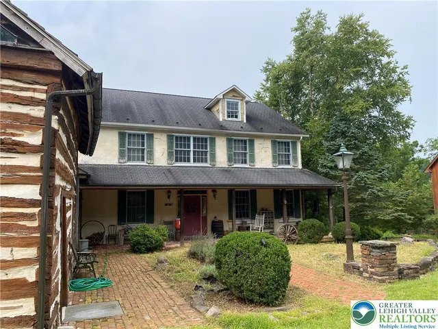 a living room with furniture a fireplace and a window