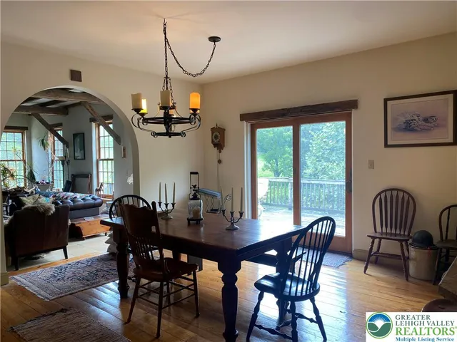 a kitchen with kitchen island granite countertop a stove a sink a dining table and chairs