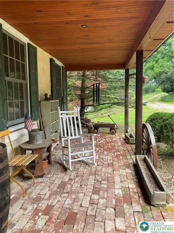 a view of a chairs and table in patio with a backyard