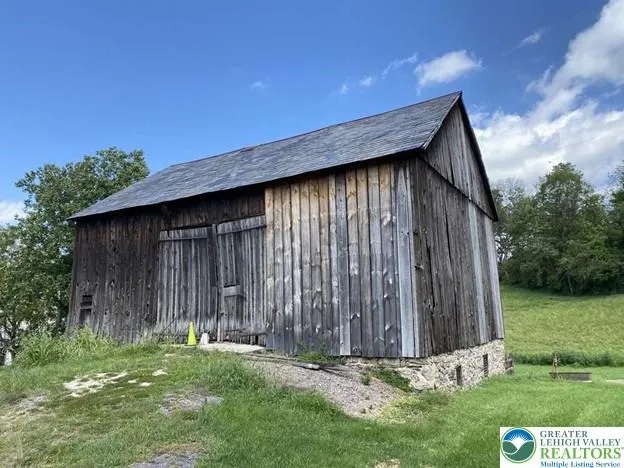 a living room with furniture a window and a lamp