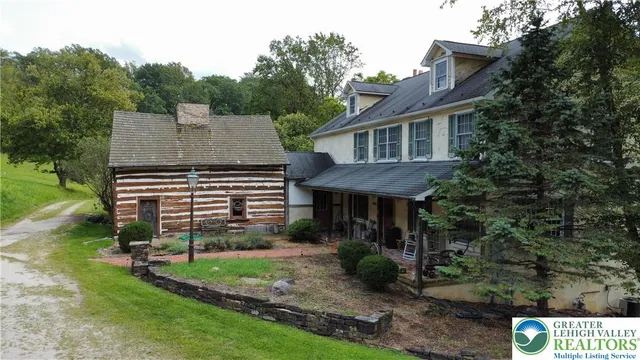 a front view of a house with a yard table and chairs