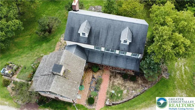 an aerial view of a house with garden space and street view