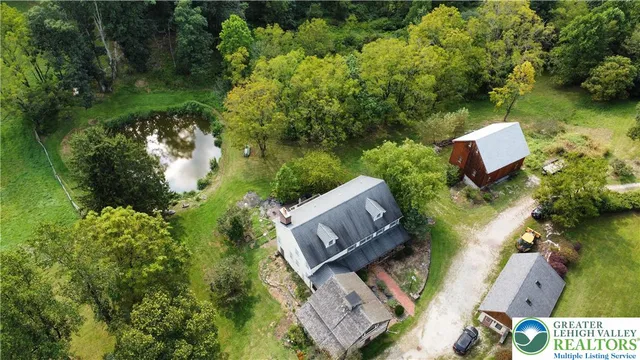 an aerial view of a house with garden space and street view