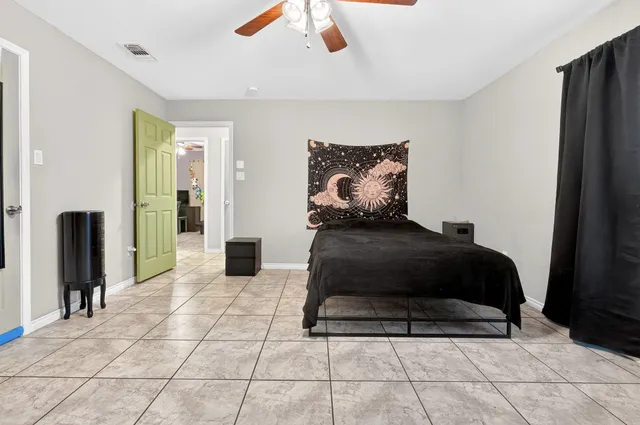 a bedroom with a bed and flat screen tv