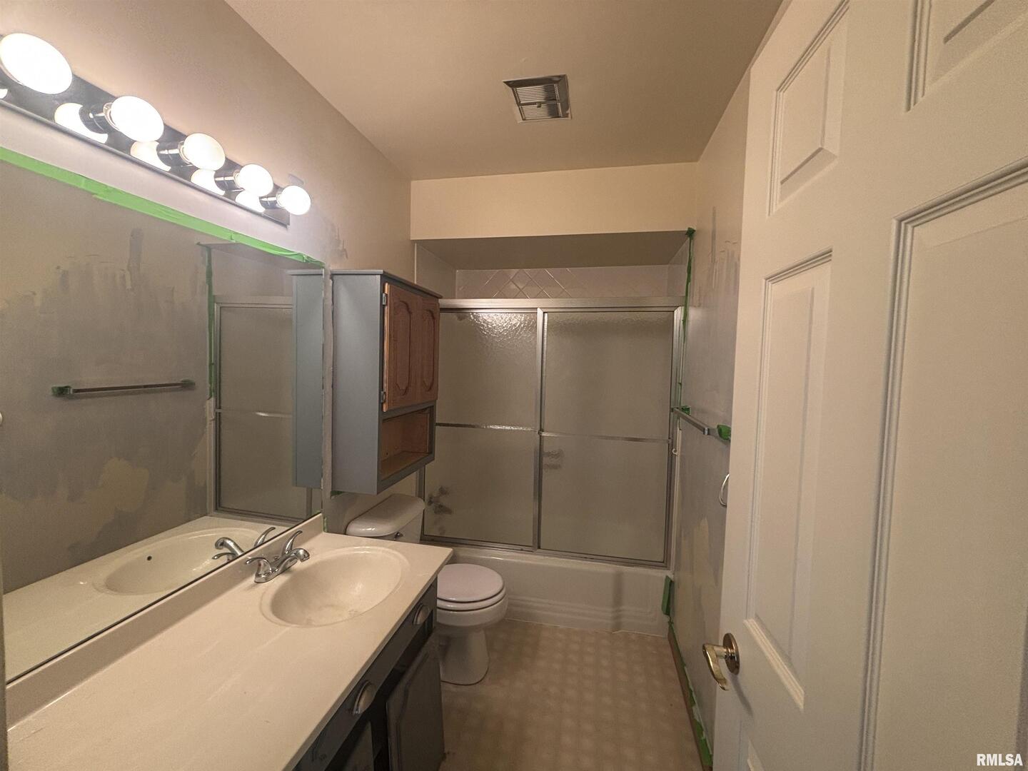 920 17th Street, Unit 28 Moline, IL 61265 - Photo 11 of 17 a bathroom with a sink mirror and a shower