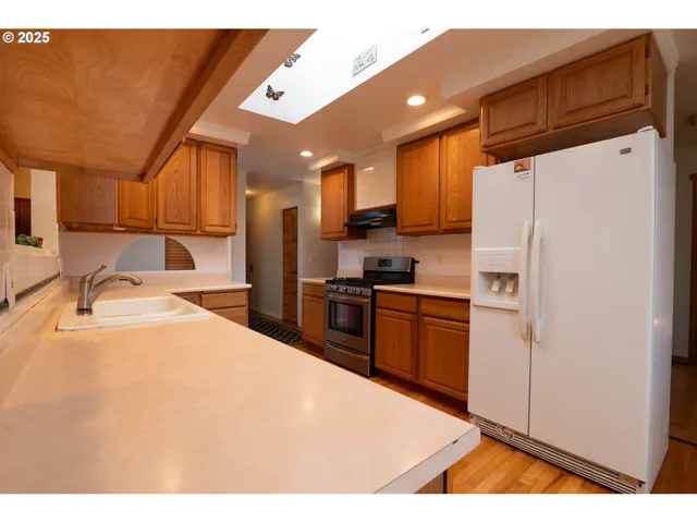 a kitchen with stainless steel appliances a refrigerator and a stove
