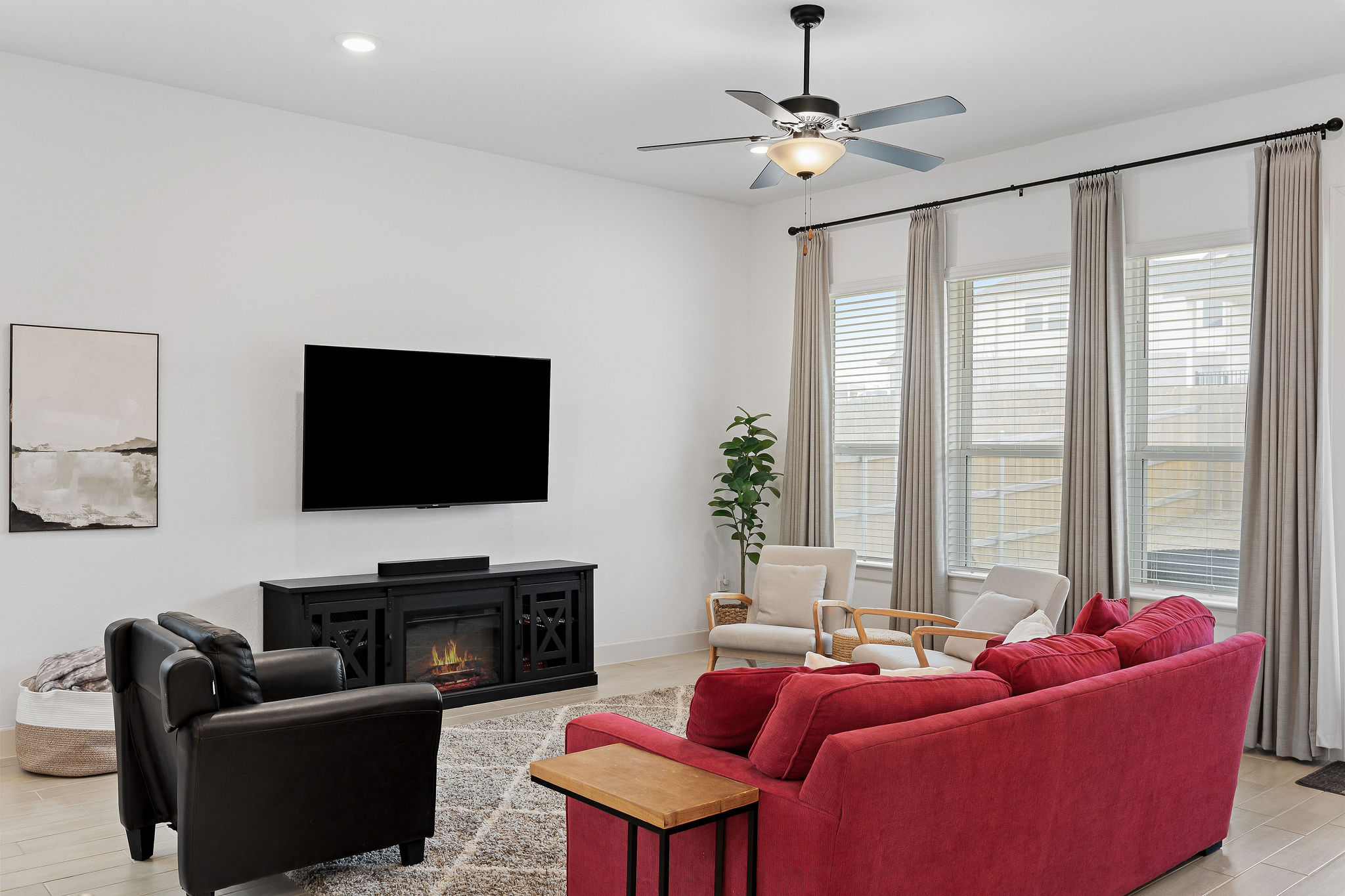 4605 Sea Salt Drive Austin, TX 78747 - Photo 13 of 40 a living room with furniture a fireplace and a flat screen tv