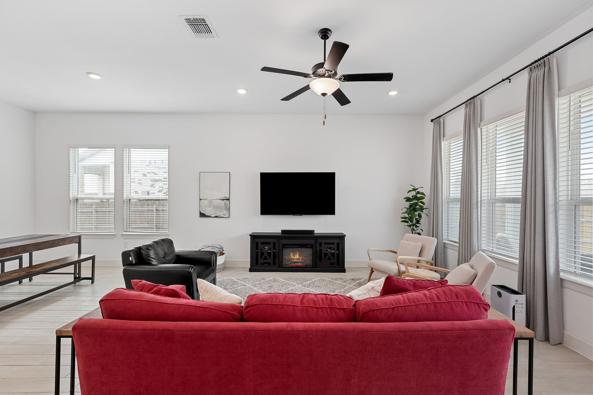 4605 Sea Salt Drive Austin, TX 78747 - Photo 16 of 40 a living room with furniture a flat screen tv and a fireplace
