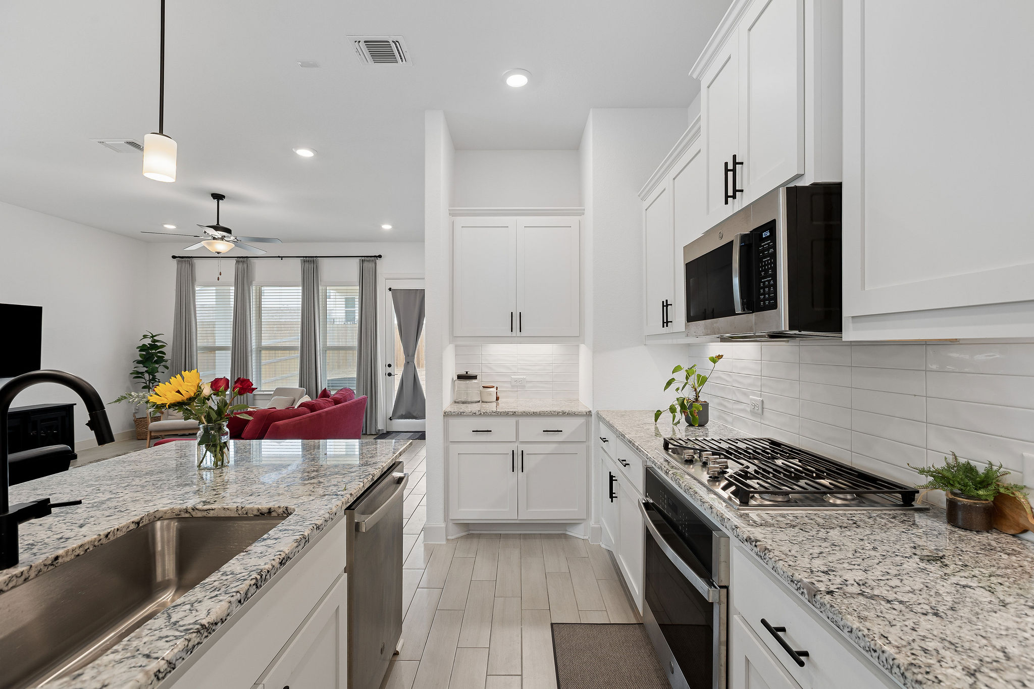 4605 Sea Salt Drive Austin, TX 78747 - Photo 6 of 40 a kitchen with stainless steel appliances granite countertop a sink stove and refrigerator