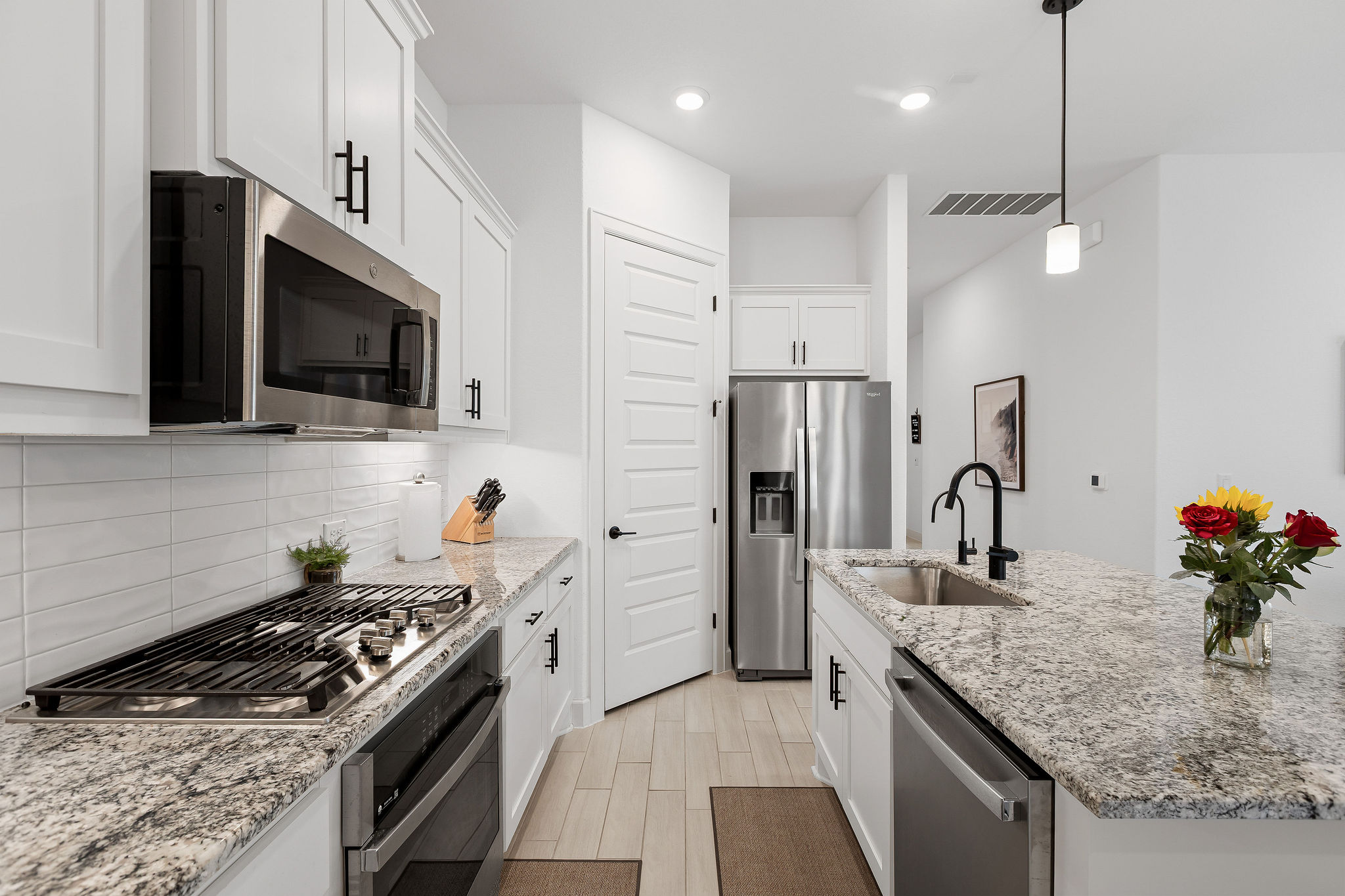 4605 Sea Salt Drive Austin, TX 78747 - Photo 8 of 40 a kitchen with stainless steel appliances granite countertop a sink stove and refrigerator