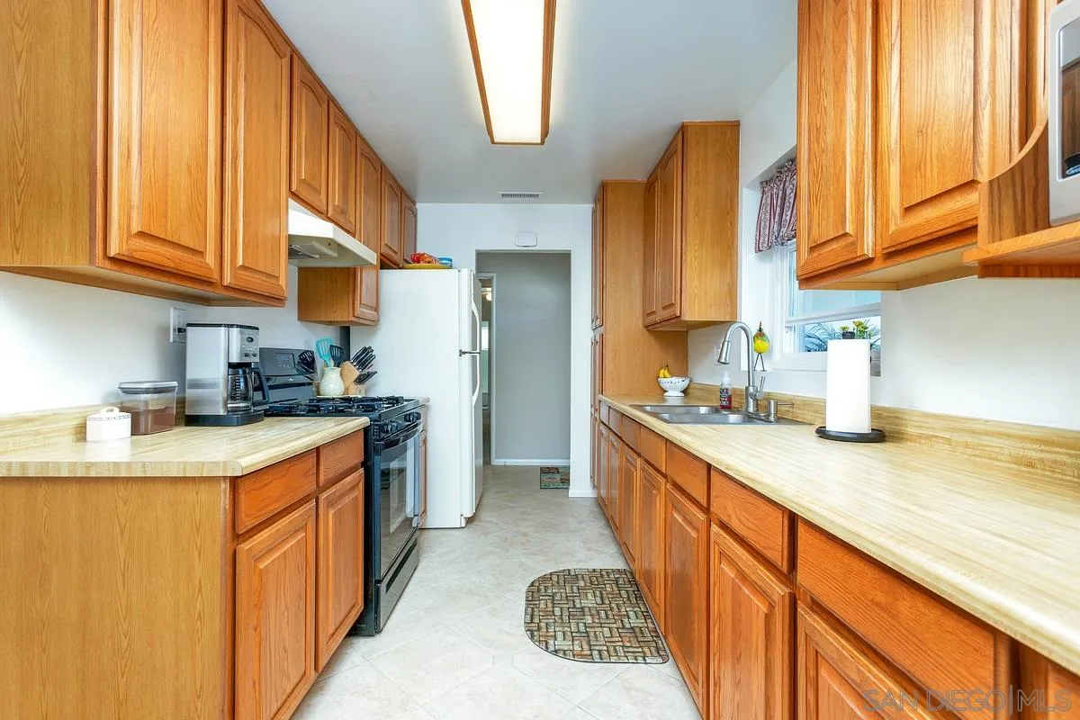 13839 Frame Road Poway, CA 92064 - Photo 10 of 35 a kitchen with stainless steel appliances granite countertop a sink a stove and a refrigerator