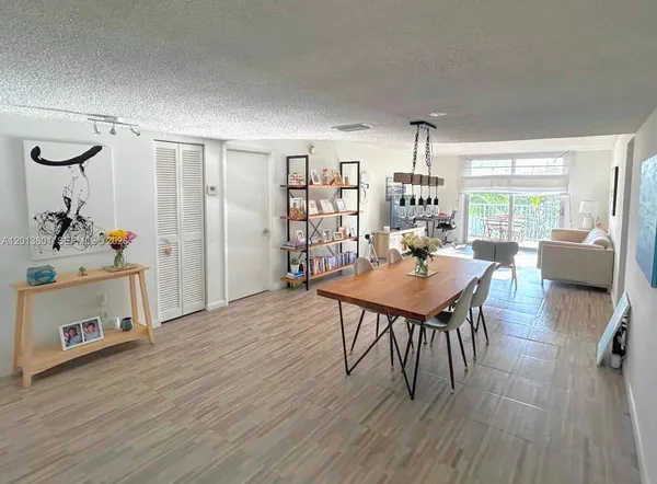 a view of a dining room with furniture window and wooden floor