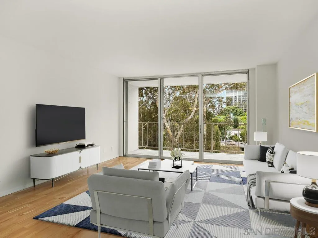 3634 7th Avenue, Unit 4B San Diego, CA 92103 - Photo 11 of 50 a living room with couch a flat screen tv and a large window