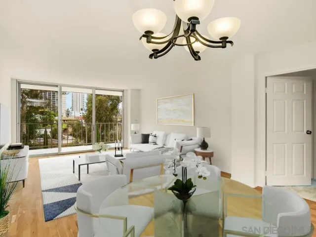 a view of a kitchen with kitchen island stainless steel appliances a sink and living room view