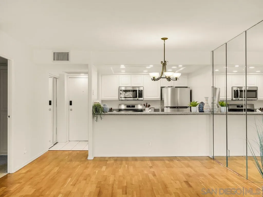 3634 7th Avenue, Unit 4B San Diego, CA 92103 - Photo 20 of 50 a view of a kitchen with kitchen island stainless steel appliances a sink and living room view