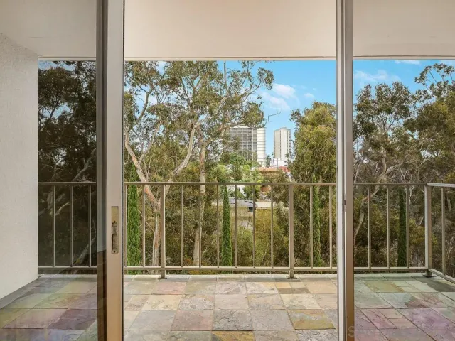 a view of a city from a hallway