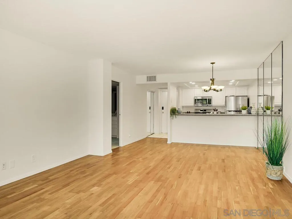 3634 7th Avenue, Unit 4B San Diego, CA 92103 - Photo 23 of 50 a view of empty room with wooden floor and kitchen
