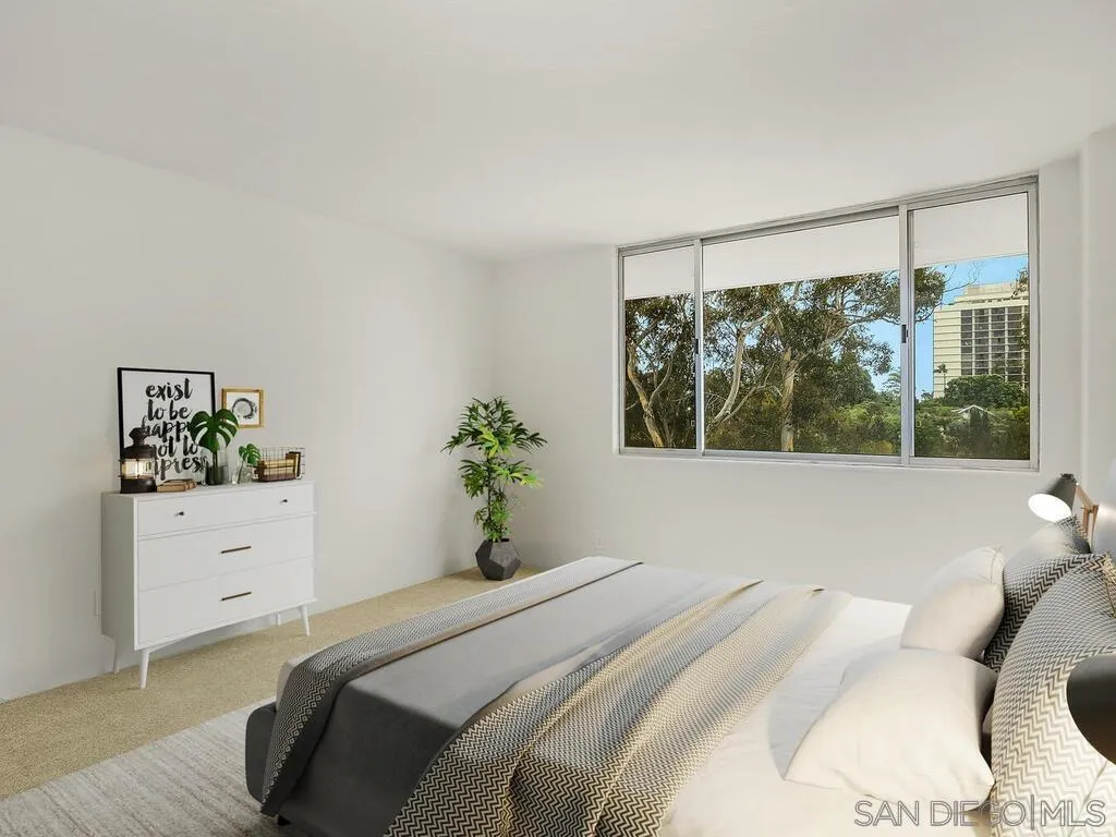 3634 7th Avenue, Unit 4B San Diego, CA 92103 - Photo 32 of 50 a bedroom with a bed and a window