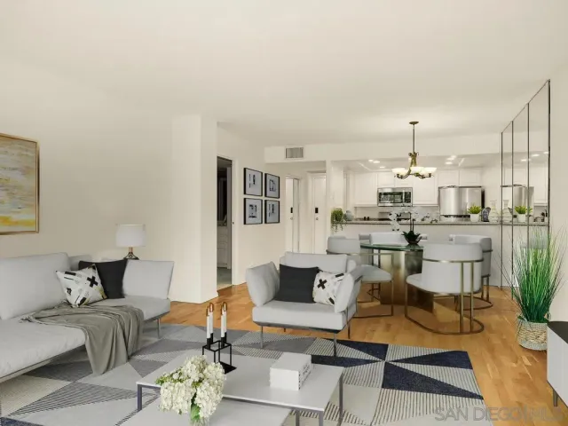 a living room with furniture and a view of kitchen