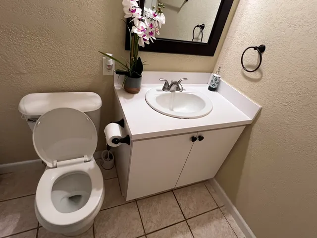 a room with water heater and wooden cabinets