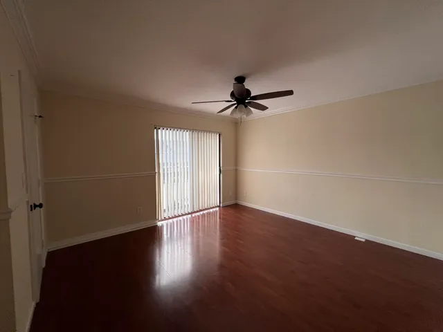wooden floor in an empty room with a window