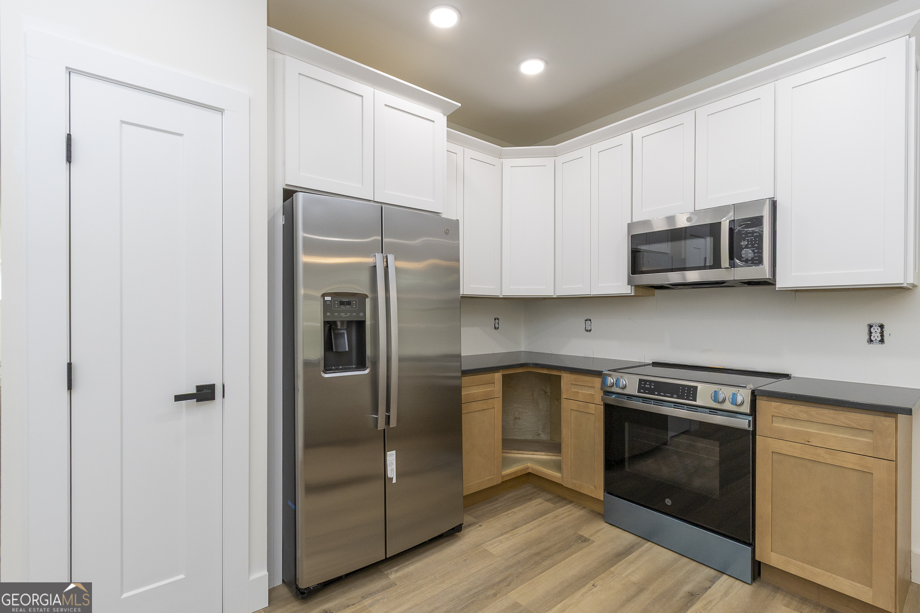 320 Thompson Street Pendleton, SC 29670 - Photo 3 of 7 a kitchen with stainless steel appliances granite countertop white cabinets and wooden floor