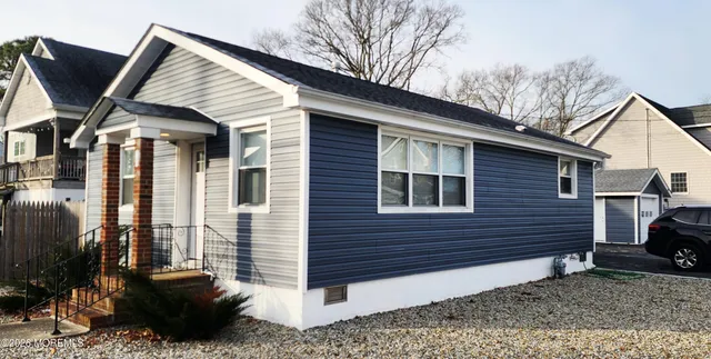 a view of a house with a yard and furniture