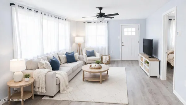 a living room with furniture and a flat screen tv
