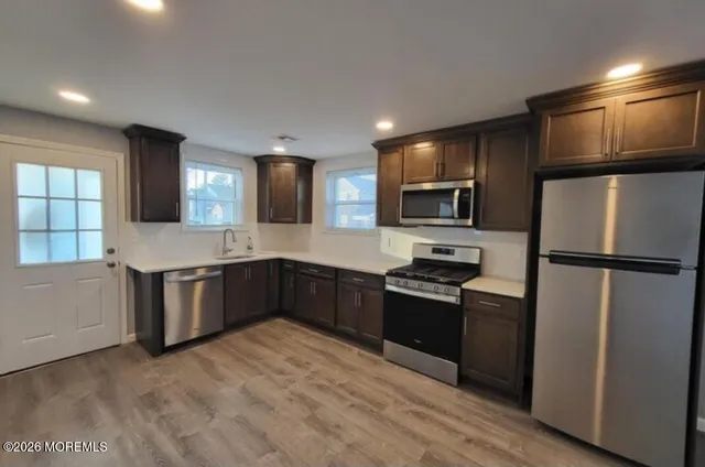 a large kitchen with a refrigerator stove and kitchen island