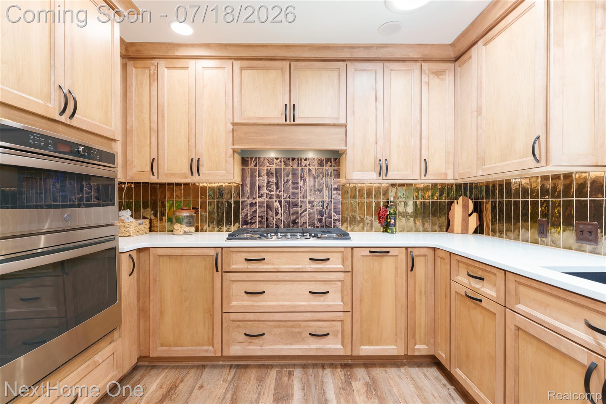 4423 Mason Road Howell, MI 48843 - Photo 8 of 29 Loads of storage in this kitchen with built in appliances that are enhanced by a vertical bronze backsplash.