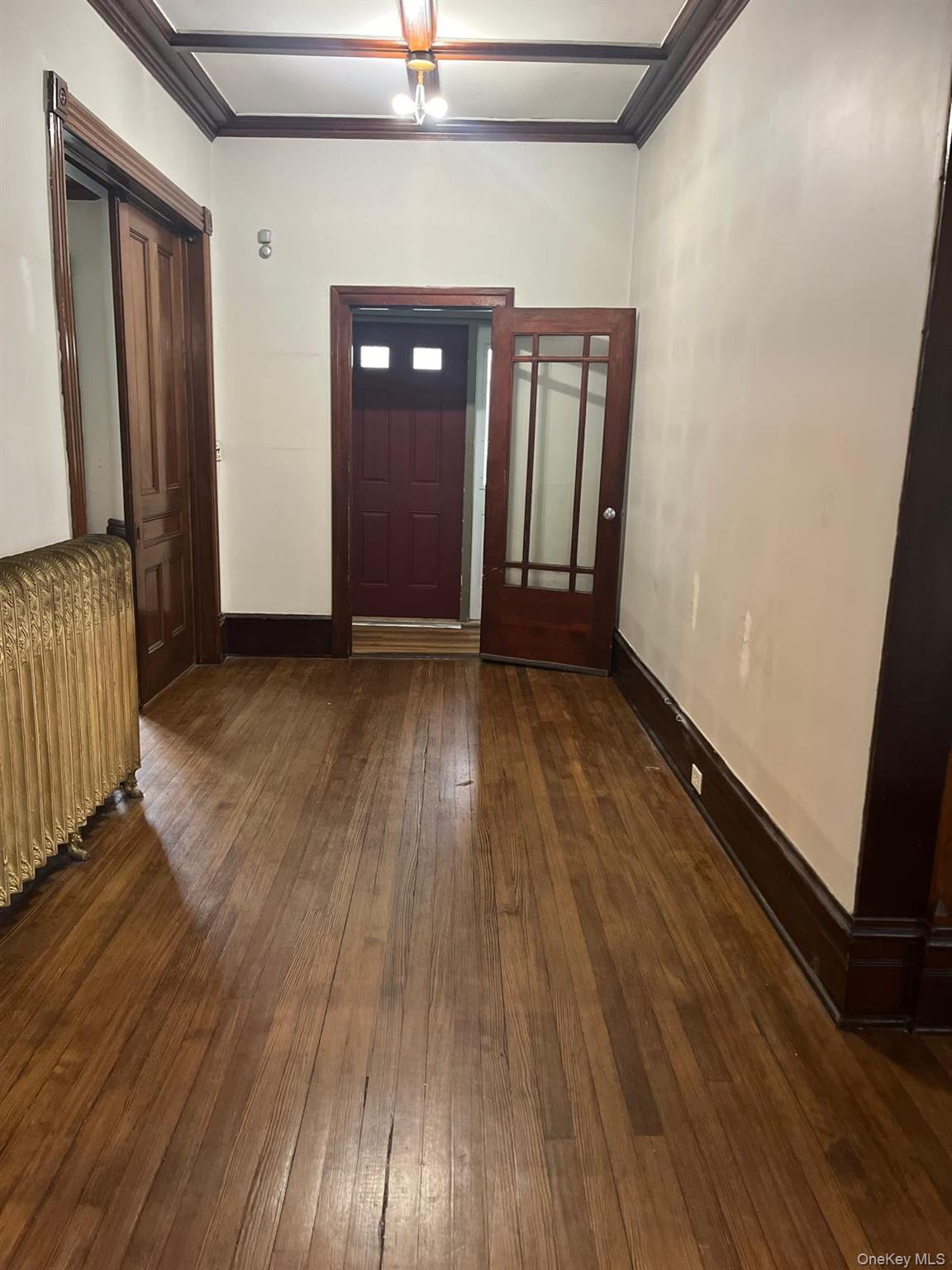 32 Balding Avenue Poughkeepsie, NY 12601 - Photo 32 of 39 Entrance foyer with dark wood-style flooring, ornamental molding, and radiator