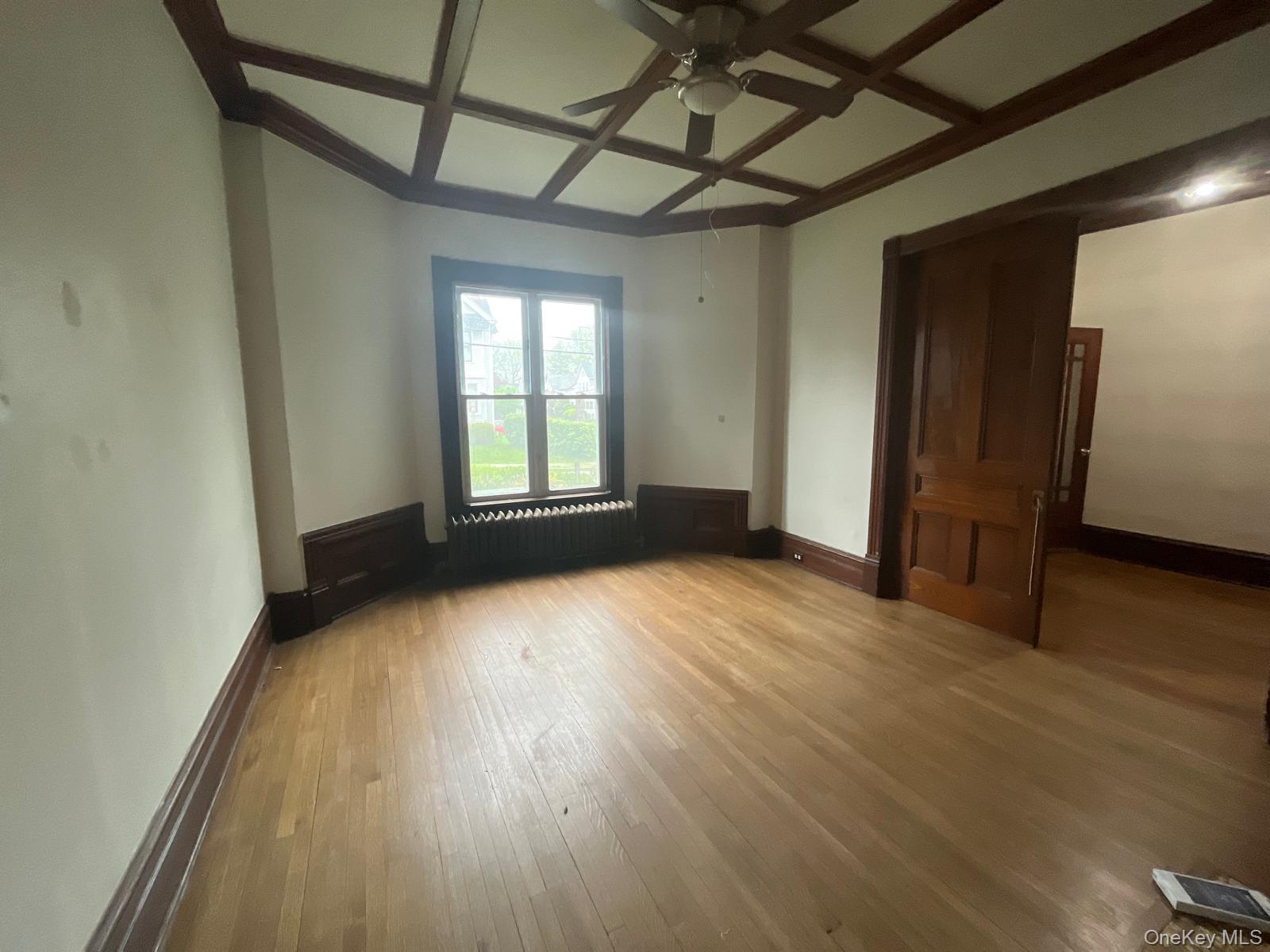 32 Balding Avenue Poughkeepsie, NY 12601 - Photo 33 of 39 Unfurnished room with coffered ceiling, light wood-style floors, ceiling fan, and beamed ceiling
