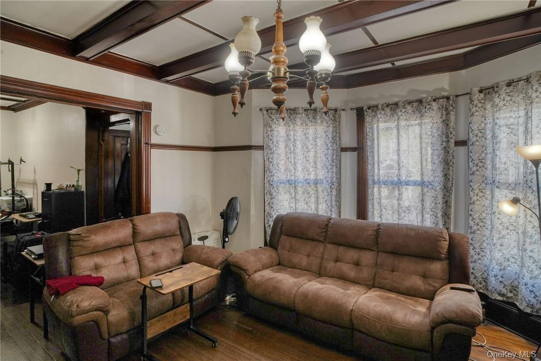 32 Balding Avenue Poughkeepsie, NY 12601 - Photo 6 of 39 Living room with beamed ceiling, a chandelier, and wood-type flooring