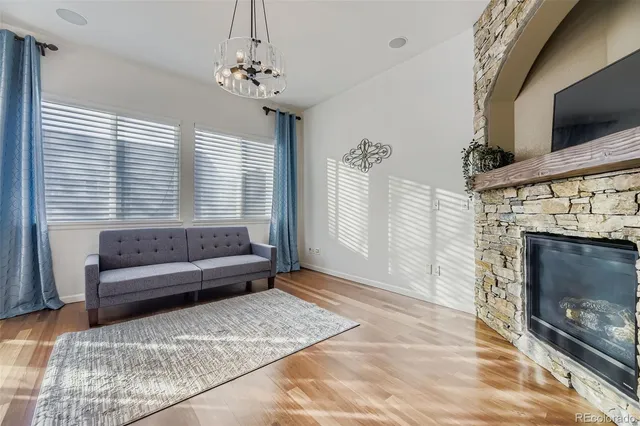 a living room with furniture a flat screen tv and a fireplace