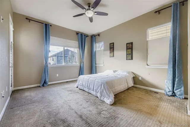 a spacious bedroom with a bed and a window