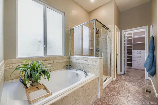 a bath tub sitting in a bathroom next to a window