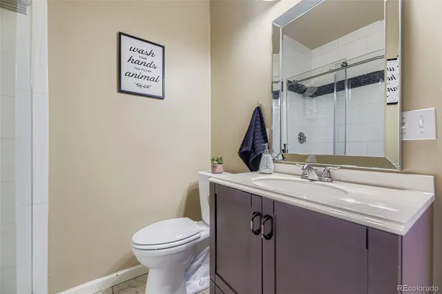 a bathroom with a sink toilet and vanity