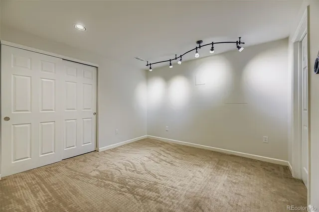 a view of a room with racks on the wall and a window