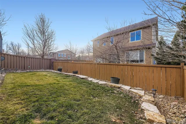 a backyard of a house with wooden fence