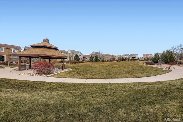 a view of a lake with a big yard and large trees