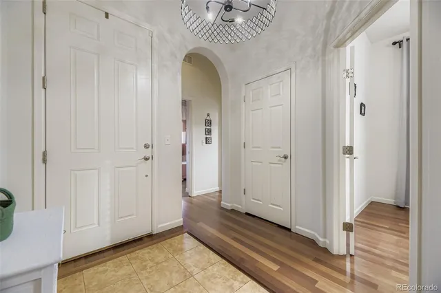a view of a hallway with wooden floor and entryway