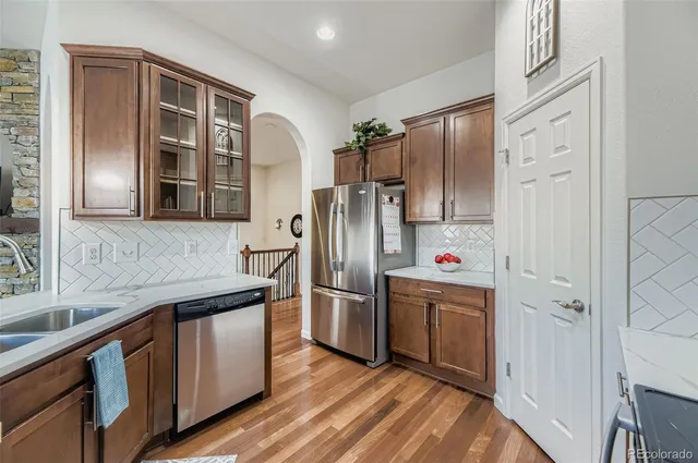 a kitchen with stainless steel appliances a refrigerator and a sink