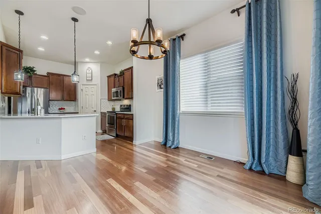 a view of kitchen with stainless steel appliances refrigerator oven and cabinets