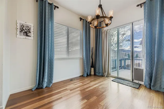 a view of a room with wooden floor and windows
