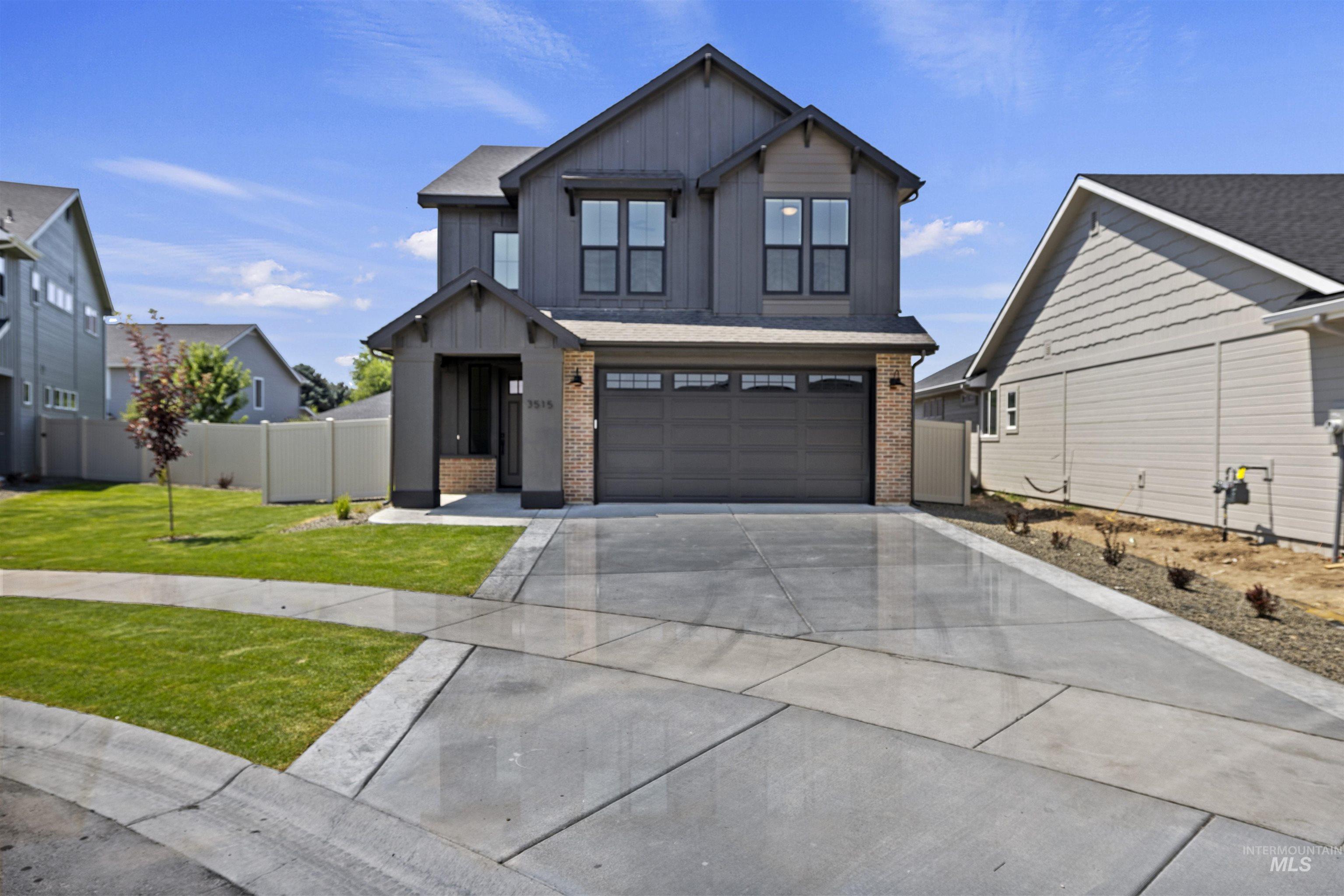 3515 South El Rio Avenue Boise, ID 83709 - Photo 1 of 47 View of front of home featuring brick siding, concrete driveway, board and batten siding, and a garage